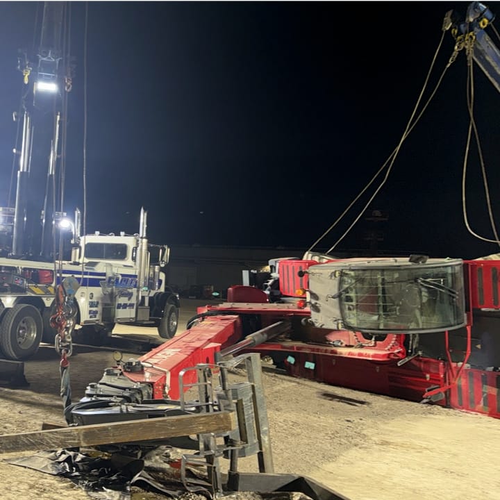 Rescue fallen bucket loader at night.